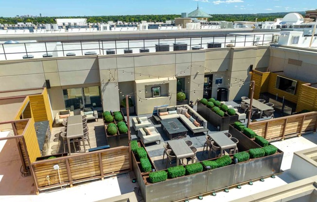 a rendering of a rooftop patio with tables and chairs