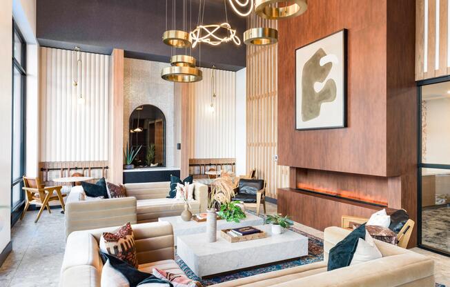 A thoughtfully layered lounge at Modera Higley Commons, where warm materials, sculptural lighting, and inviting seating set the tone for relaxed gatherings.