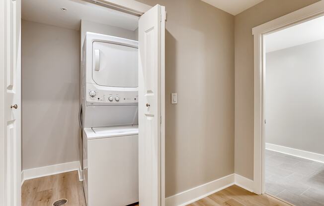 A small white oven and microwave are built into a wall in a kitchen.
