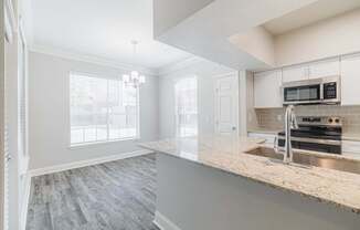 a kitchen with a marble counter top and a sink