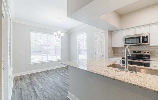 a kitchen with a marble counter top and a sink