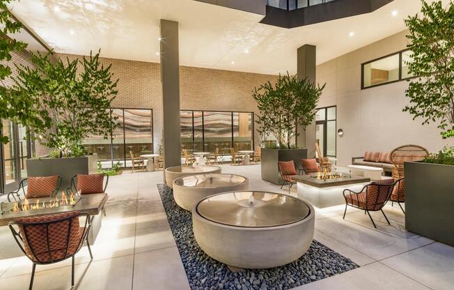 Relax in the serene courtyard with tranquil water features, cozy fire pits, and comfortable seating among lush greenery—ideal for quiet evenings or casual conversations.