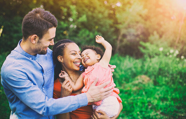 a man and woman holding a baby at Brownstones at Palisade Park Townhomes, Colorado, 80023