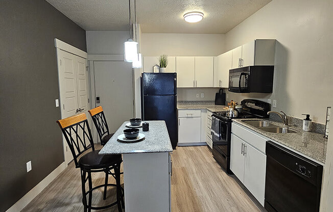 a kitchen with stools from The Lotus Apartments in Downtown Salt Lake City, Utah