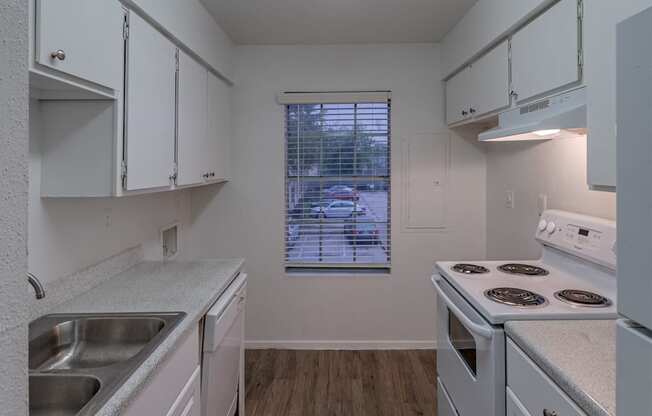 a kitchen with with appliances and white cabinets