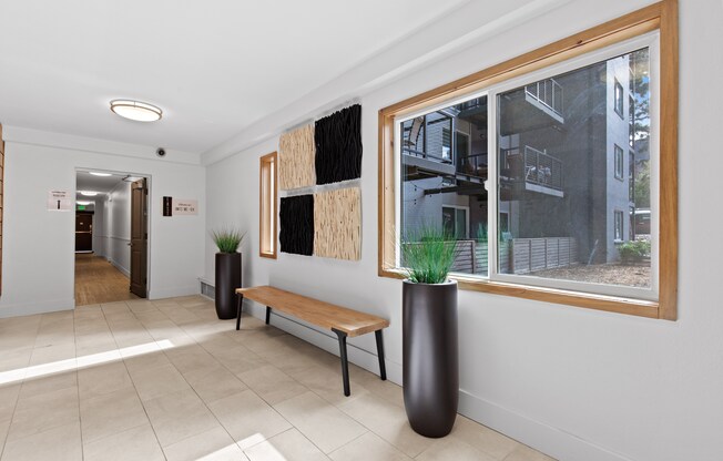 a hallway with a bench and a large window