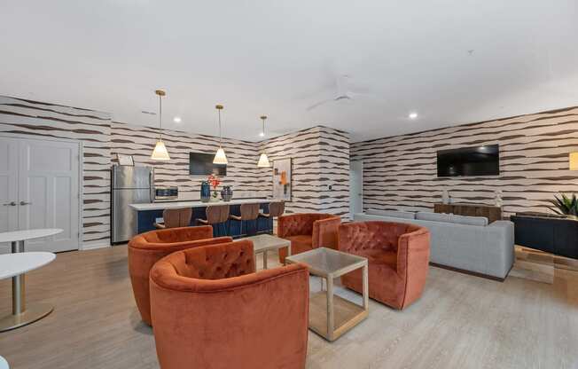 a living room with couches and chairs and a kitchen