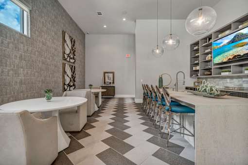A modern dining room with a long table and chairs.