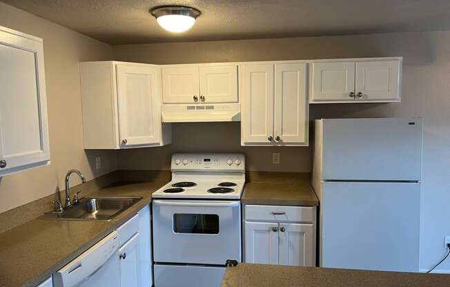 a kitchen with white appliances and white cabinets