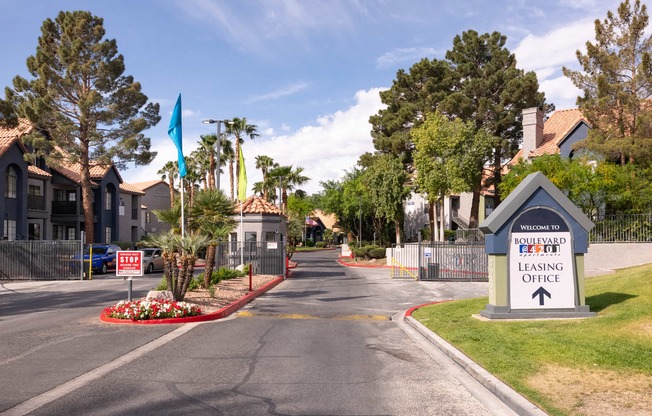 an empty street with a sign for a lease office at the end of a road