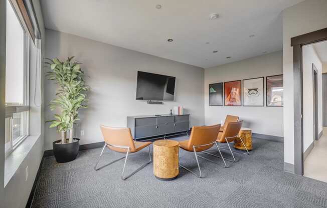 media room with a tv and a table and chairs