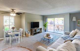 A living room with a white couch and a television.