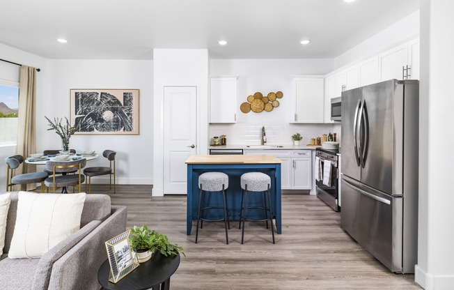 Your dream kitchen awaits at Aster Ridge. Enjoy quartz countertops, white shaker cabinets, and a stunning tile backsplash, all complemented by ENERGY STAR® stainless steel appliances.