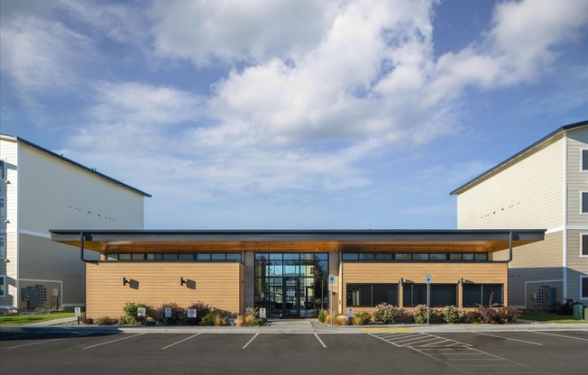 the front of a building with a parking lot