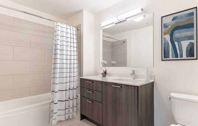 a bathroom with a toilet sink and shower and a mirror at One 333, Chicago, IL, 60605