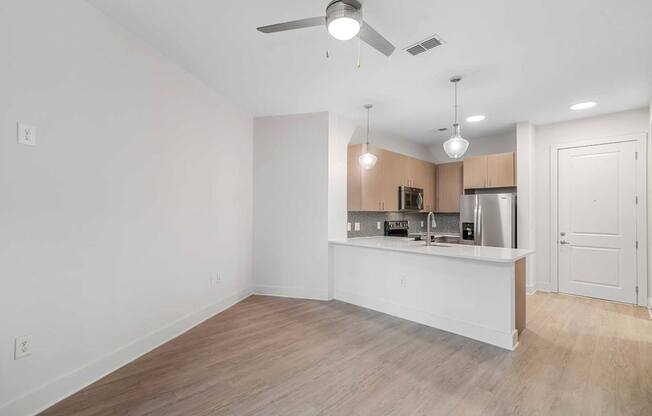 A kitchen area with a counter and cabinets.