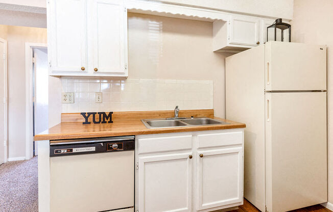 Classic Kitchen with White Cabinets and Almond Colored Appliances