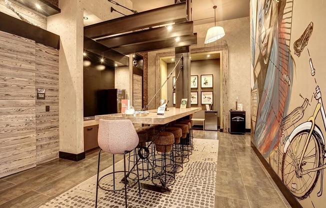 a bar with stools and a table in a lobby