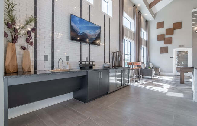 a large kitchen with a large window and a tv on the wall