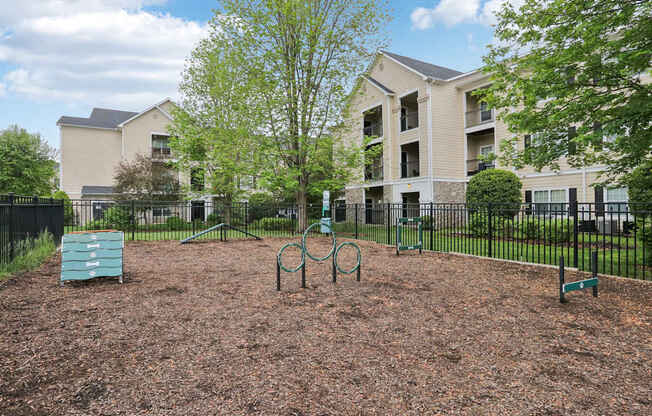 A playground area in front of apartment buildings.