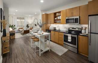 a kitchen and dining room with wooden cabinets and stainless steel appliances