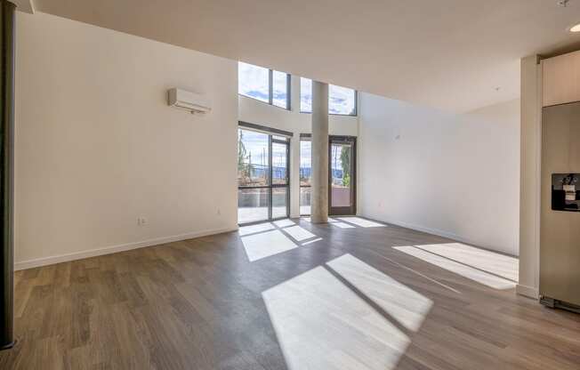 a living room with hardwood floors and white walls at Marina Square, Bremerton, Washington 98337