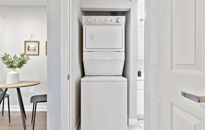 a white washer and dryer in a white kitchen