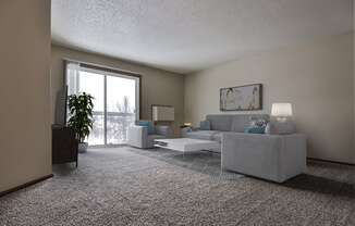 Grand Forks Primrose Apartments.  a living room with a couch and a chair with a glass sliding door