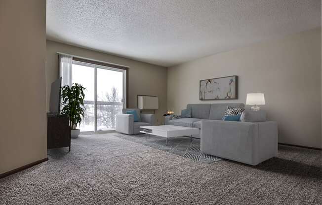 Grand Forks Primrose Apartments.  a living room with a couch and a chair with a glass sliding door