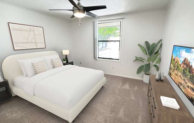 A bedroom with a large bed, a ceiling fan, and a flat-screen TV.