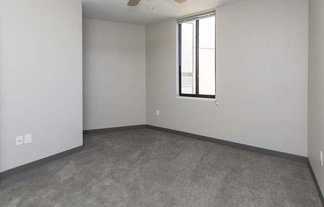 Spacious living room with neutral walls and ample natural light.