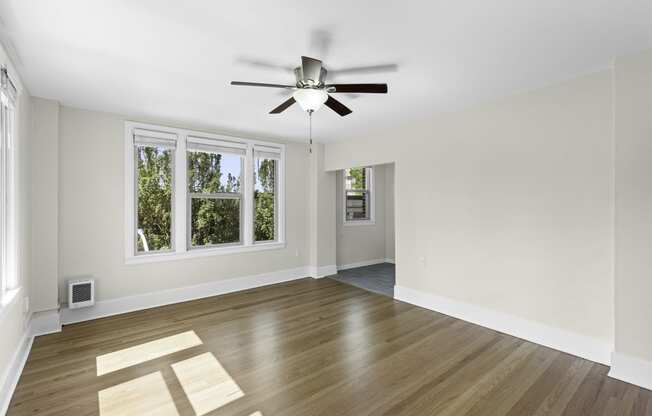 a living room with hardwood floors and a ceiling fan at Stockbridge Apartment Homes, WA 98101