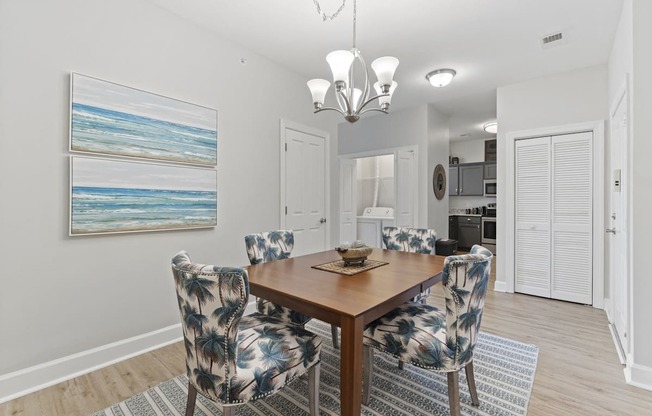 A dining room with a wooden table and chairs with a blue and white pattern.