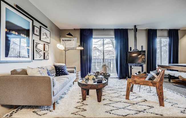 A living room with a couch, coffee table, and fireplace.