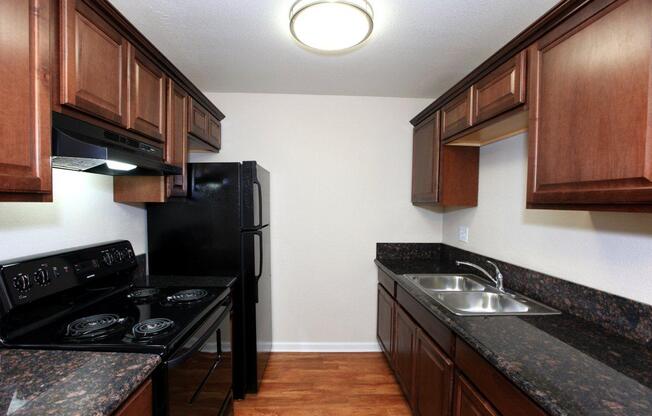 a modern kitchen with stainless steel appliances and wooden cabinets
