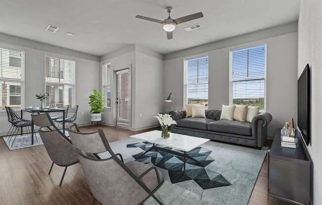 A modern living room with a grey sofa, a coffee table, and a television.