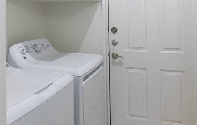 A white washer and dryer in a small laundry room.