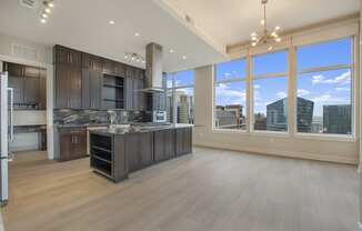 a large kitchen with a large window overlooking a city