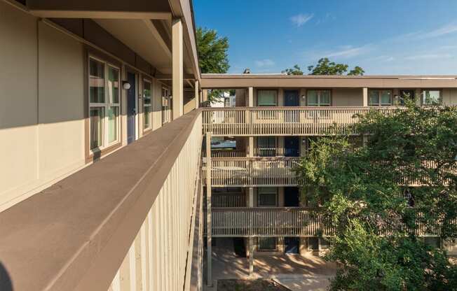 This is a photo of apartment entrances in the courtyard at Harvard Square Apartments, in the Vickery Meadow neighborhood of Dallas, TX.