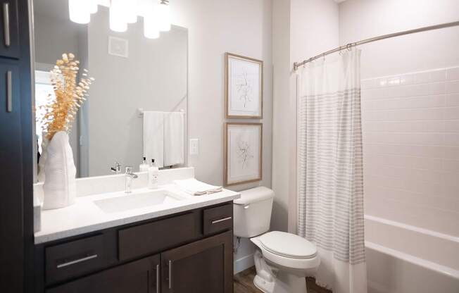 a bathroom with a toilet sink and bathtub in a 555 waverly unit