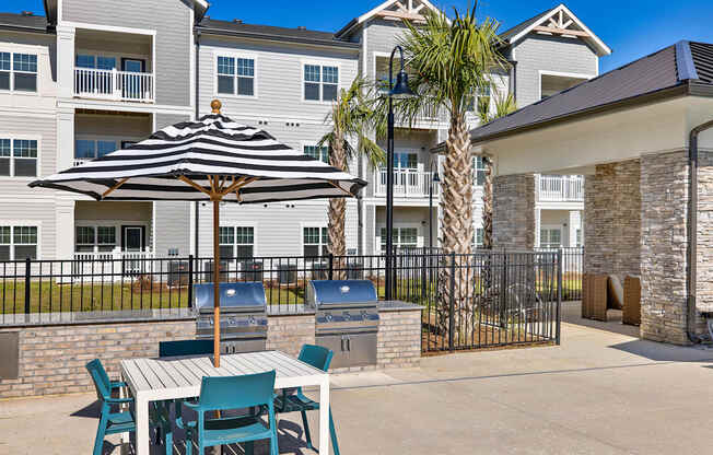 A patio with a table and chairs and a palm tree.
