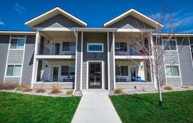 a building with a sidewalk in front of it at Madison Park, Bozeman, MT