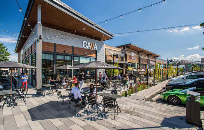 a rendering of people sitting at tables outside of a restaurant