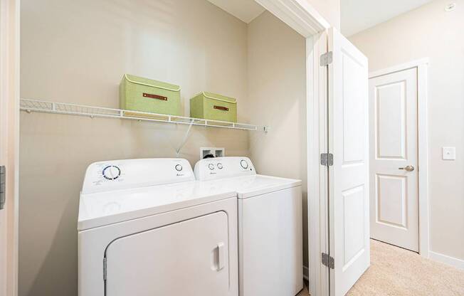 A white washer and dryer in a laundry room.