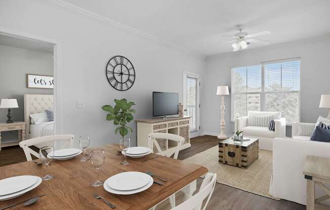 A dining room with a wooden table set for two.
