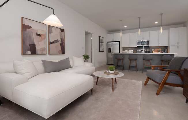 a living room with a white couch and a table