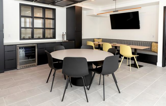 a conference room with a round table and chairs