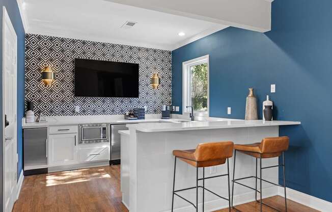 A kitchen with blue walls and white countertops.