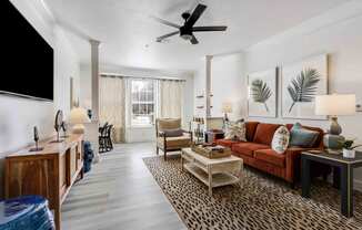 a living room with a couch and a ceiling fan