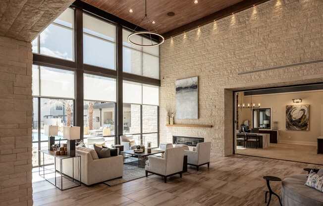A modern living room with a fireplace and a large window.